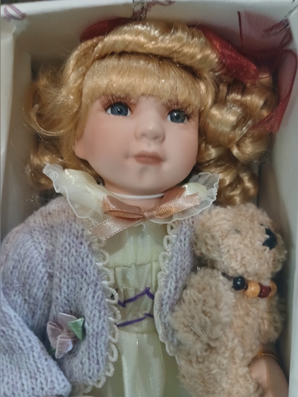 Porcelain Doll with Blue Eyes and Blonde Hair in Lavender Sweater And Teddy Bear